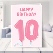 10th birthday card for girls shown in a living room