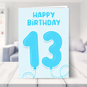 13th birthday card for boys shown in a living room