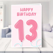 13th birthday card for girls shown in a living room