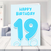 19th birthday card for boys shown in a living room