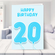 20th birthday card for him shown in a living room
