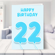 22nd birthday card for him shown in a living room