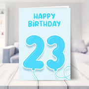 23rd birthday card for him shown in a living room