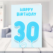 30th birthday card for him shown in a living room