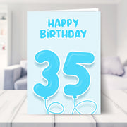 35th birthday card for him shown in a living room