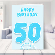 50th birthday card for him shown in a living room