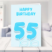 55th birthday card for him shown in a living room