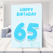 65th birthday card for him shown in a living room