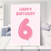 6th birthday card for girls shown in a living room