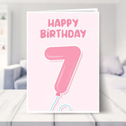 7th birthday card for girls shown in a living room