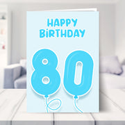 80th birthday card for him shown in a living room