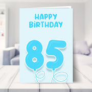 85th birthday card for him shown in a living room