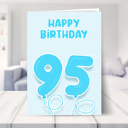 95th birthday card for him shown in a living room