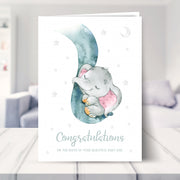 new baby girl card shown in a living room