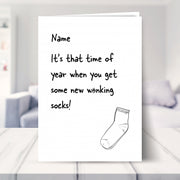 humorous christmas cards shown in a living room