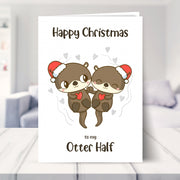 otter christmas card shown in a living room
