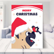pug christmas card shown in a living room