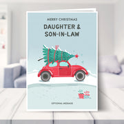 daughter and son-in-law christmas card shown in a living room