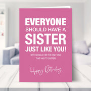 funny birthday card for sister shown in a living room