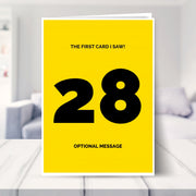 funny 28th birthday card shown in a living room