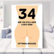 funny 34th birthday card shown in a living room