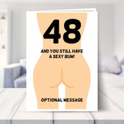funny 48th birthday card shown in a living room