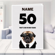 funny 50th birthday card shown in a living room