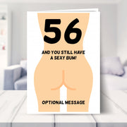 funny 56th birthday card shown in a living room
