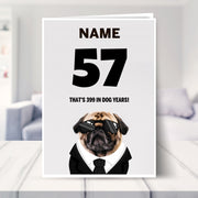 funny 57th birthday card shown in a living room