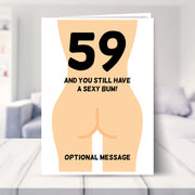 funny 59th birthday card shown in a living room