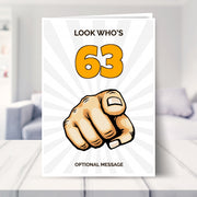 funny 63rd birthday card shown in a living room