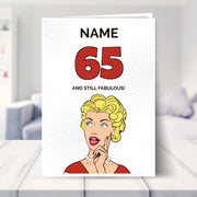 funny 65th birthday card shown in a living room