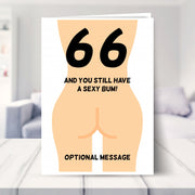 funny 66th birthday card shown in a living room