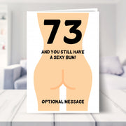 funny 73rd birthday card shown in a living room