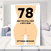 funny 78th birthday card shown in a living room