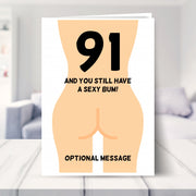 funny 91st birthday card shown in a living room