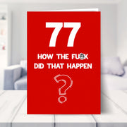 funny 77th birthday card shown in a living room