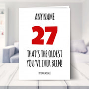 funny 27th birthday card shown in a living room