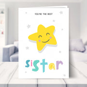 little sister birthday card shown in a living room