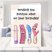 funny birthday card for women shown in a living room