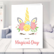 unicorn birthday card shown in a living room