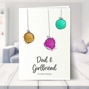 Dad & Girlfriend christmas card shown in a living room