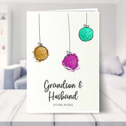 Grandson & Husband christmas card shown in a living room