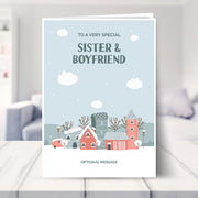 sister and boyfriend christmas card shown in a living room