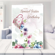 sister birthday card shown in a living room