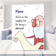 humorous christmas cards shown in a living room